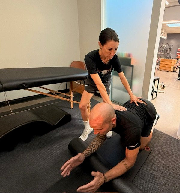 Dr. Dara performing hands-on physical therapy on a client at Sundays Cycles Santa Monica